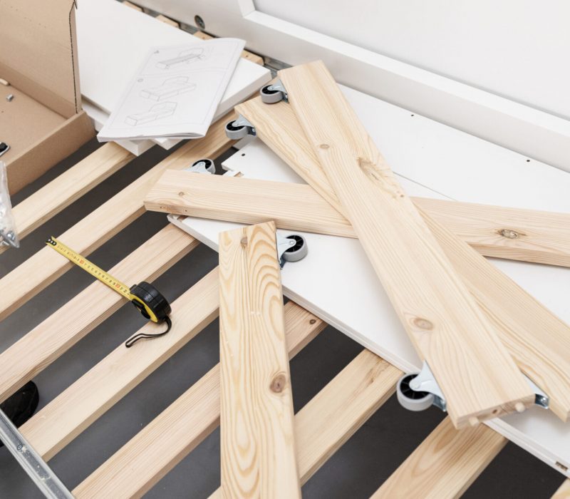 View of a bed being assembled. Furniture assembly